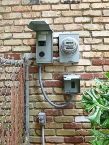 charging station electrical boxes and meter mounted on a brick wall