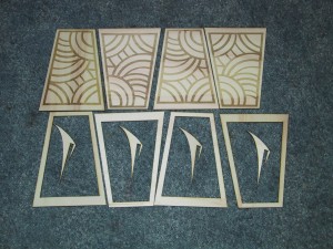 Parts for one bracer (4 panels, 4 frames, 4 spikes) laying unassembled