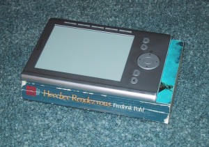 A Sony pocket reader (PRS-300) on top of a (slightly larger) paperback book.