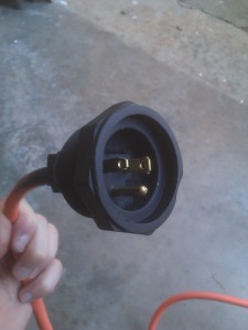 A power plug designed to be screwed into a panel.