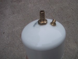 3" pvc pipe cap with a hose bib and vacuum gauge connection inserted