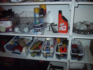 Garage shelves organized with door bins and vegtable crisper drawers from a fridge