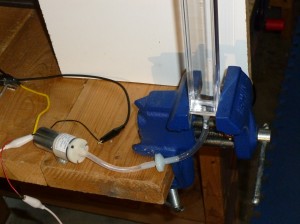 12 volt air pump, connected to a check valve, connected to the bottom of a column of water in a square extruded acrylic tube
