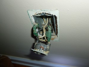 lamp cord soldered to the wires on the back of an outlet