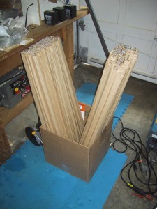 a large number of finished tubes sitting upright in a cardboard box