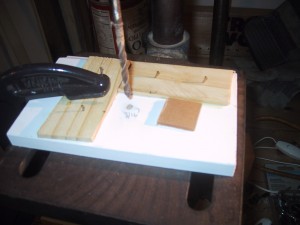 3/16" hole in a centering jig clamped to a drill press