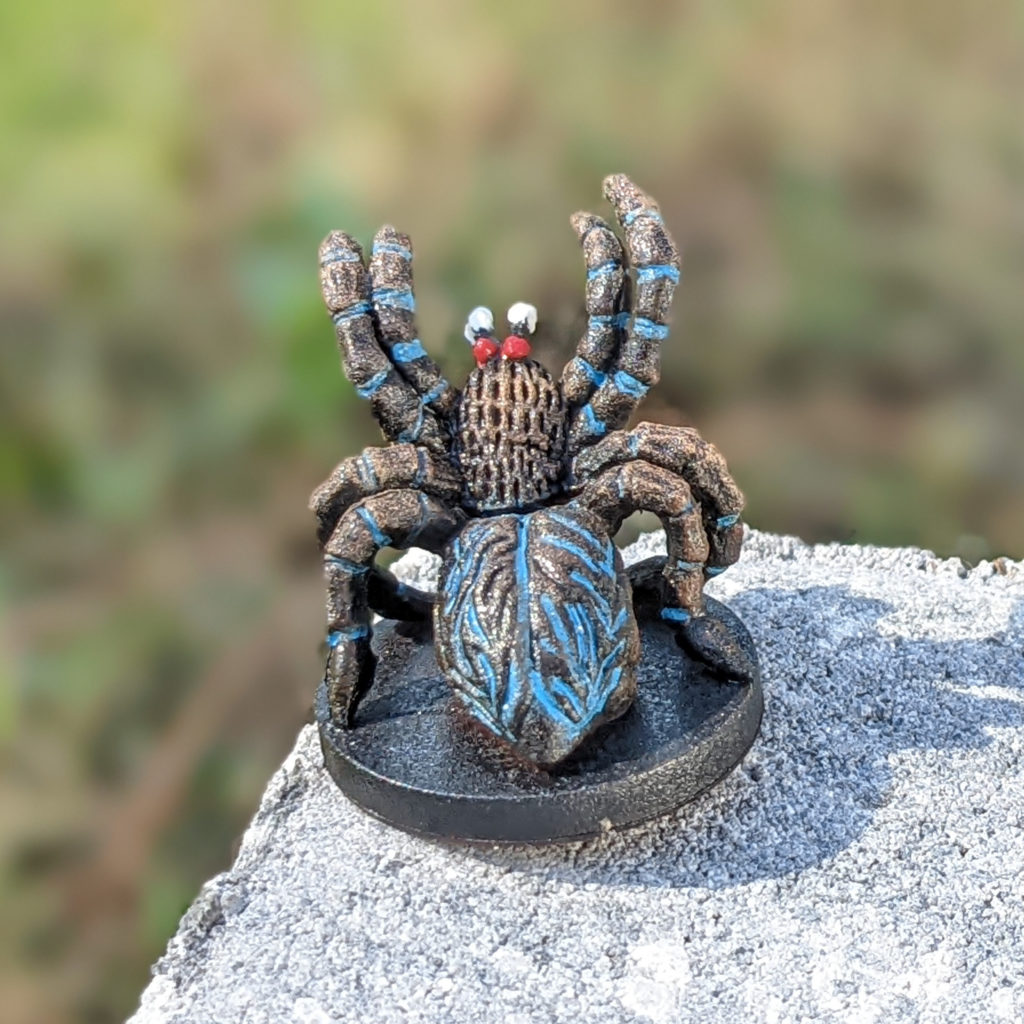 Painted model spider with blue accents.
