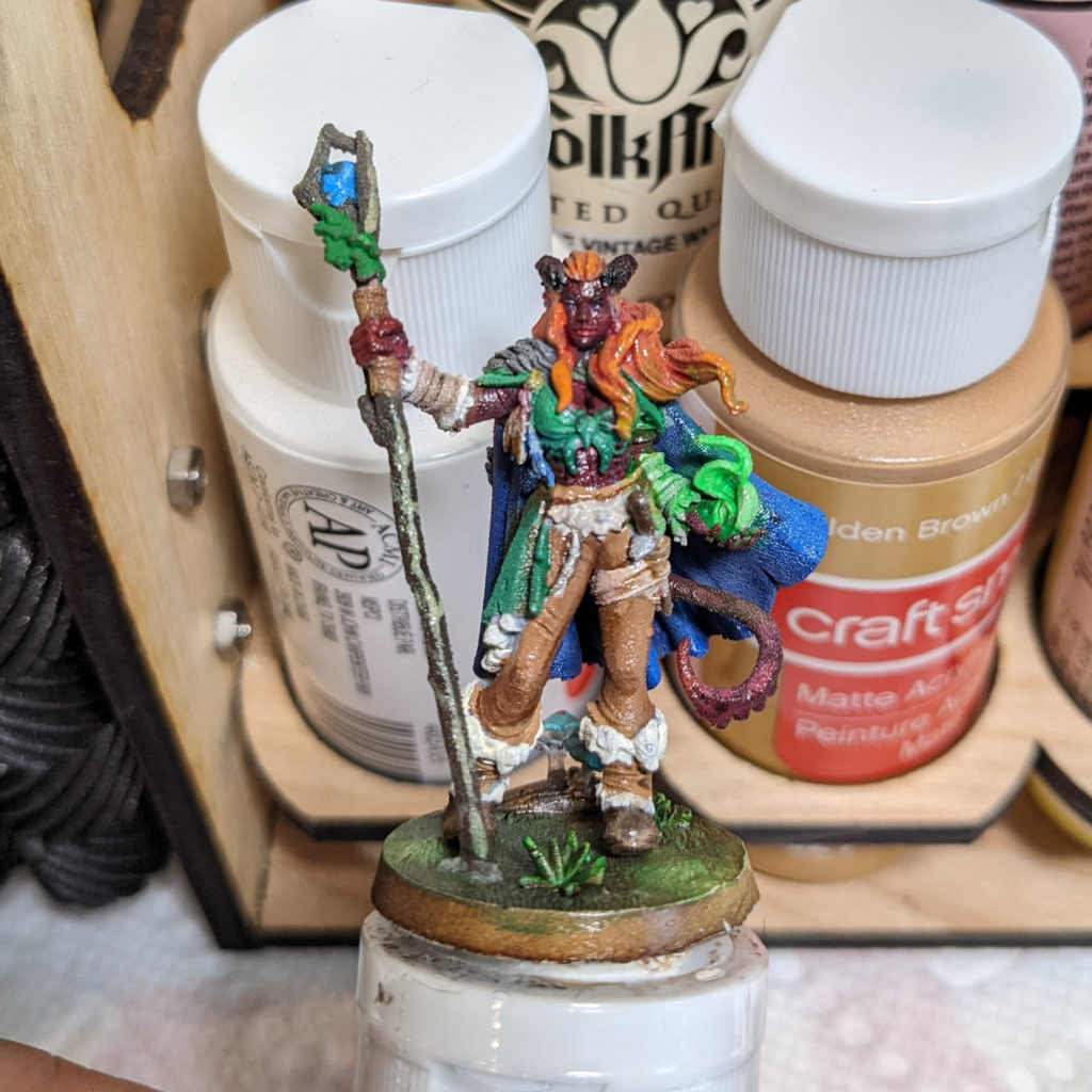 painted figure of a female tiefling druid for tabletop games
