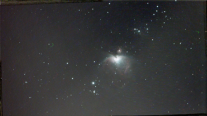 astronomy photo of the M42 Orion Nebula in front of a star field