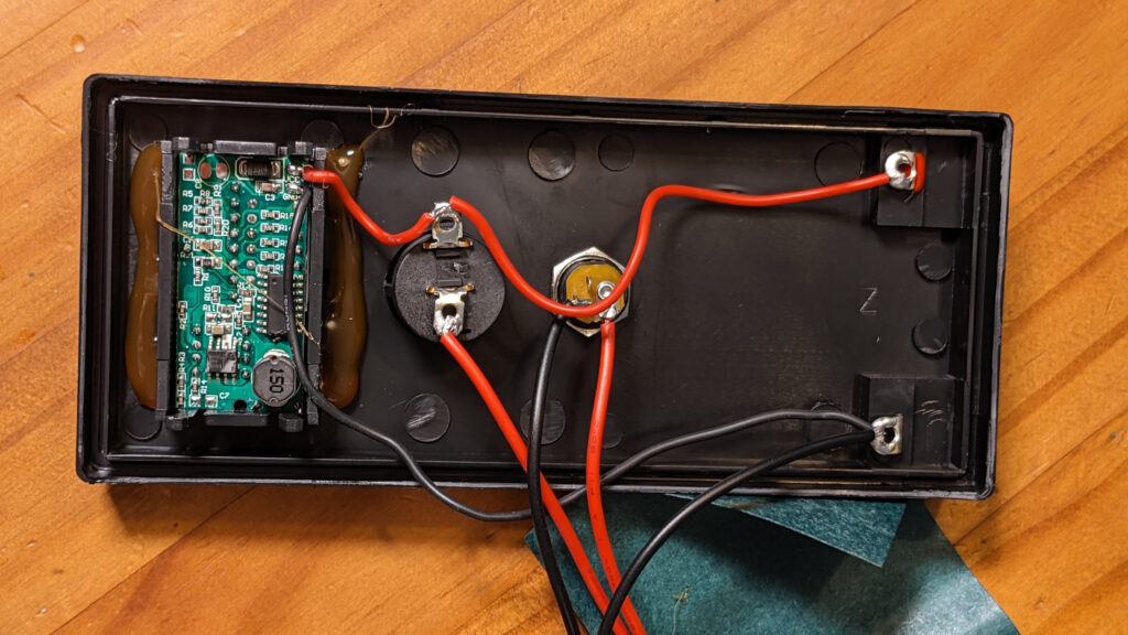 underside of the lid showing the battery voltage display with 2x USB-A ports, charging barell connector, and switch to turn off power to terminals and USB module